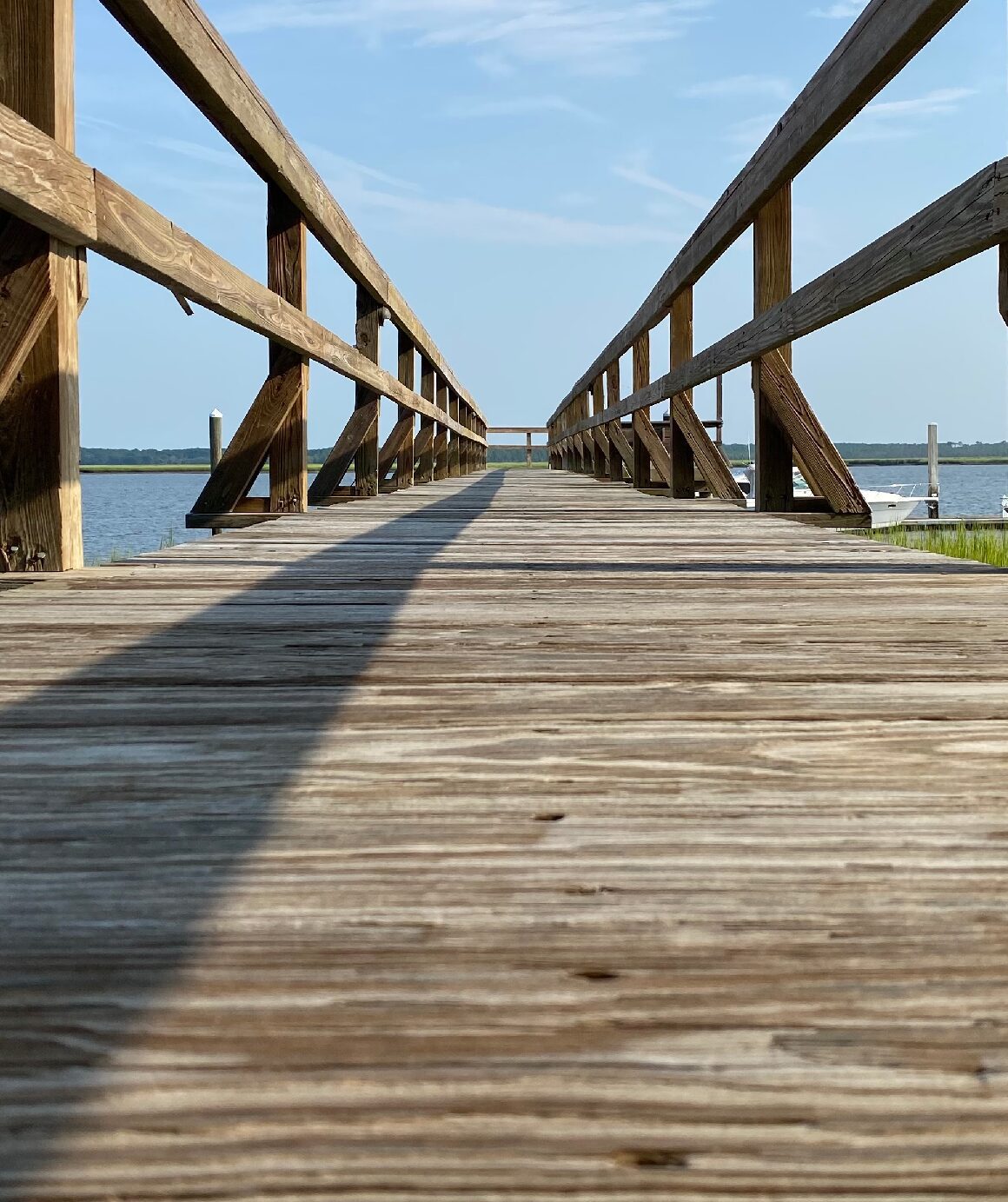 Rustic boardwalk reaching toward horizon